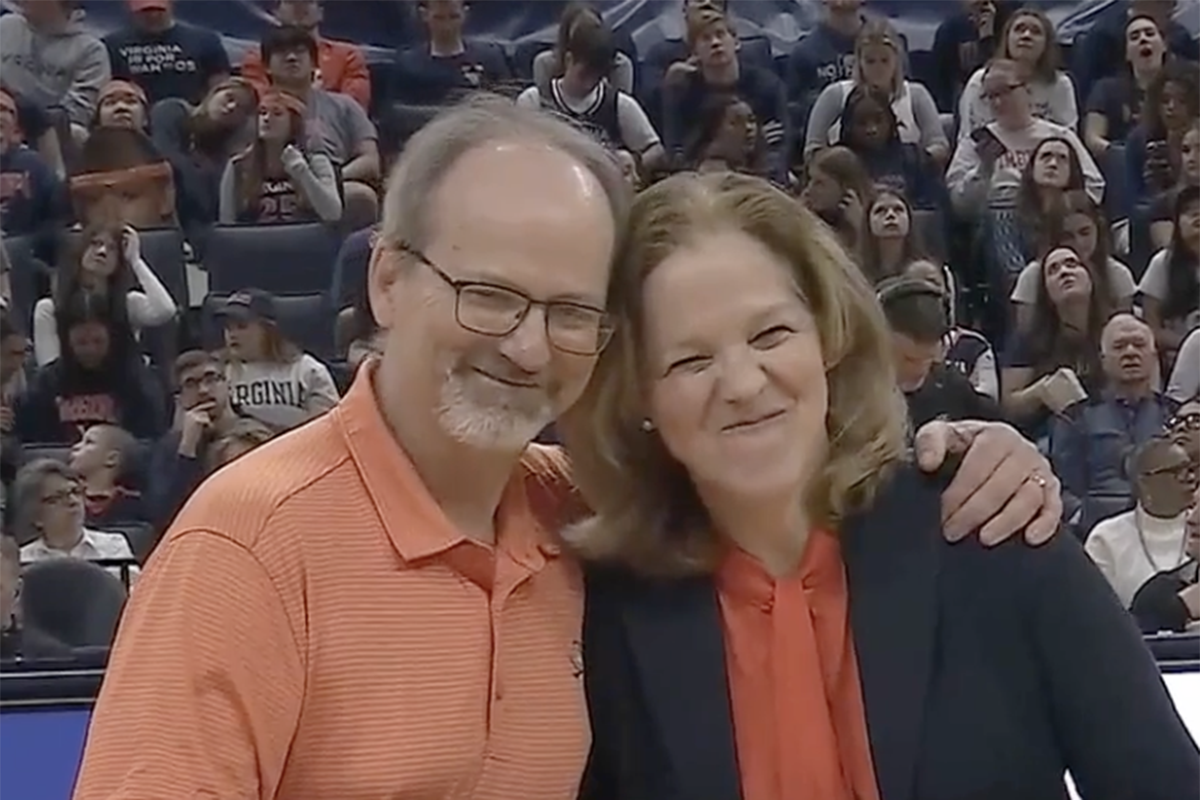 Charles Friel, MD, was honored at a UVA basketball game by Leigh Cantrell, associate director of clinical affairs for UVA Cancer Center.