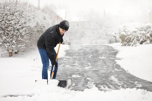 Man shoveling snow off of his driveway
