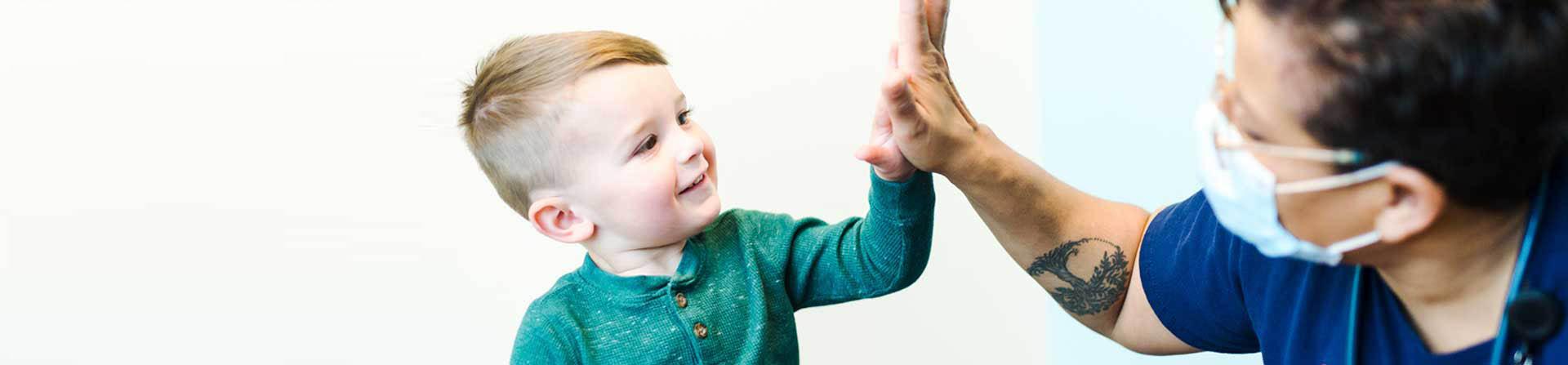kid high fiving nurse