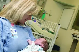 Kim Carson cuddles a preemie at UVA's Neonatal Intensive Care Unit