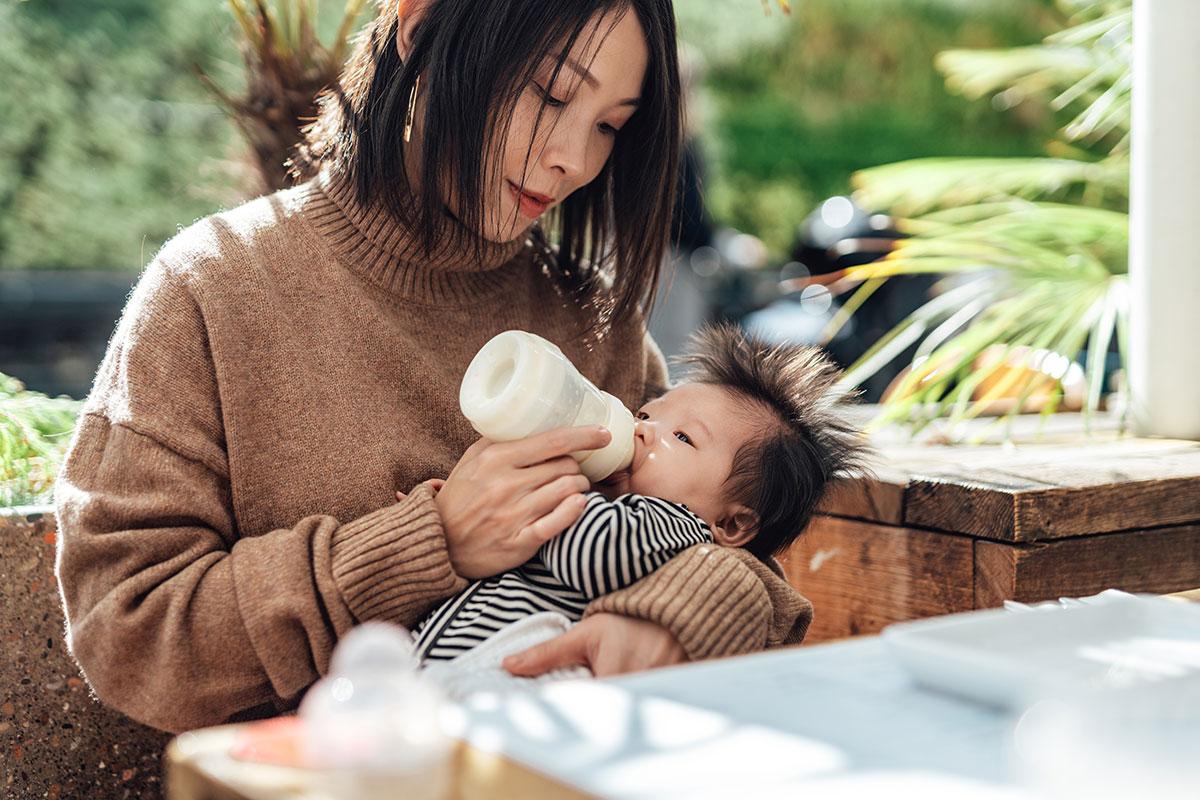 A mother feeds her baby during the baby formula shortage