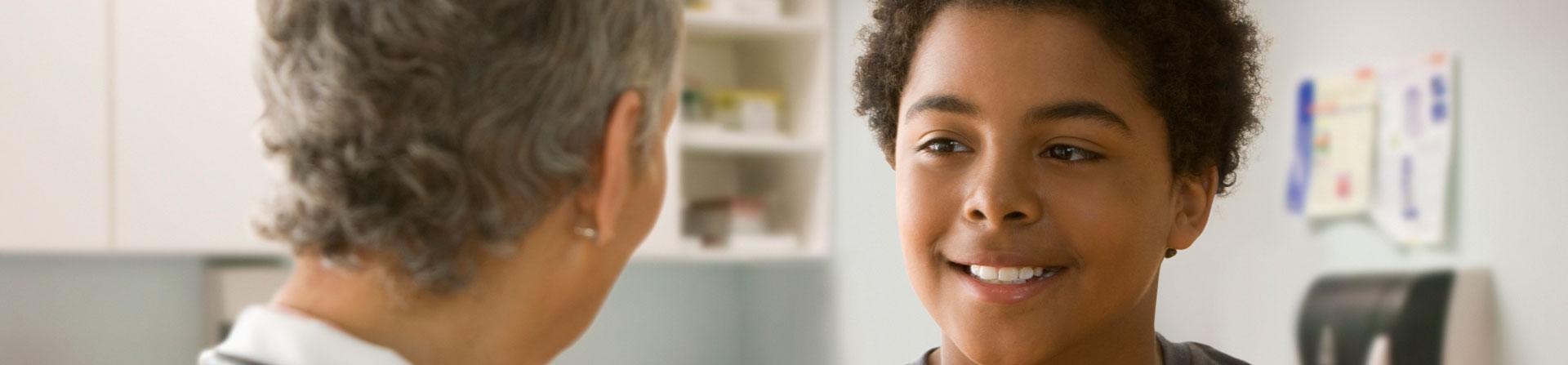young boy meeting with his pediatrician