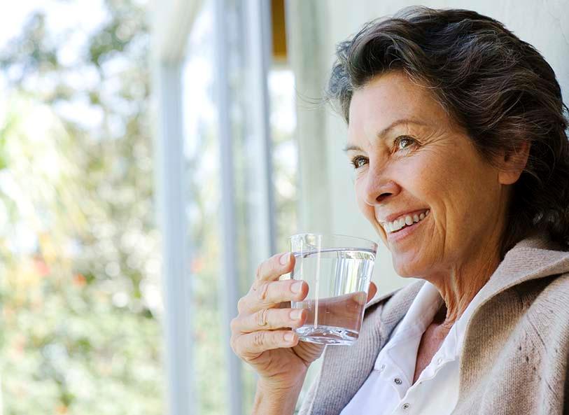 woman drinking a glass of water
