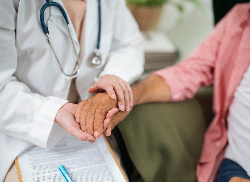 A clinician comforts a patient