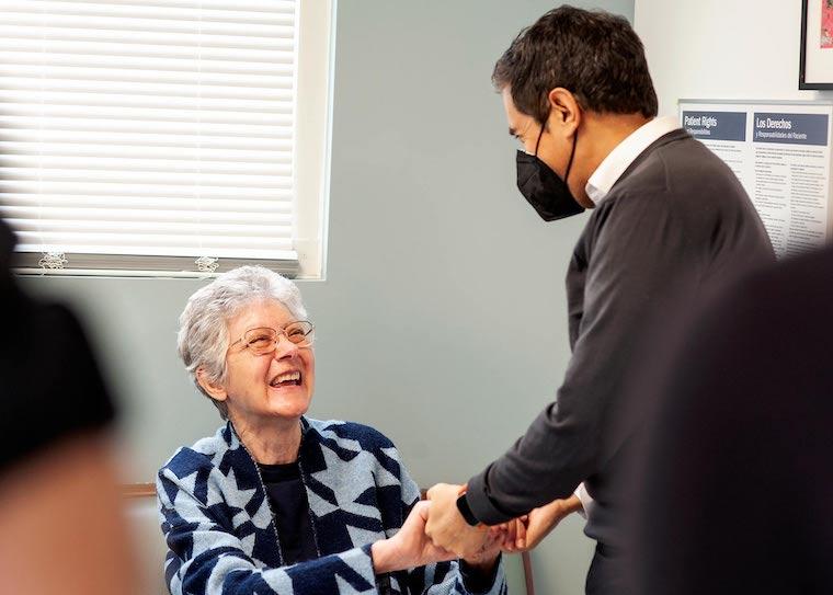 CNN's Sanjay Gupta greets patient Brenda Hric before her focused ultrasound procedure for essential tremor. Photo by Kay Taylor | UVA Health.
