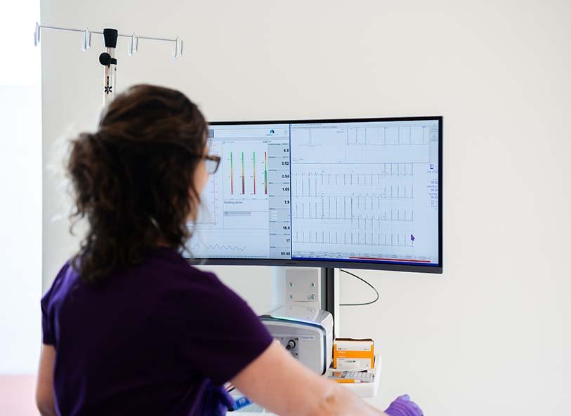 Pediatric provider looks at test results during heart stress test