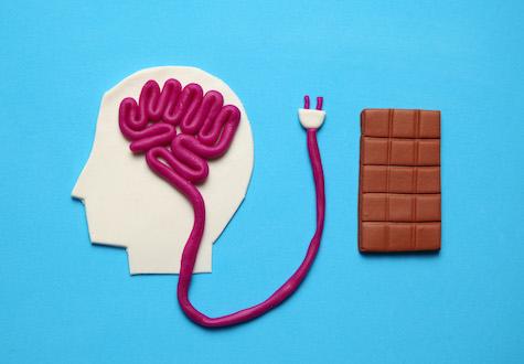 Figure of man and bar of sweet chocolate. Nutrition brain energy for mind.