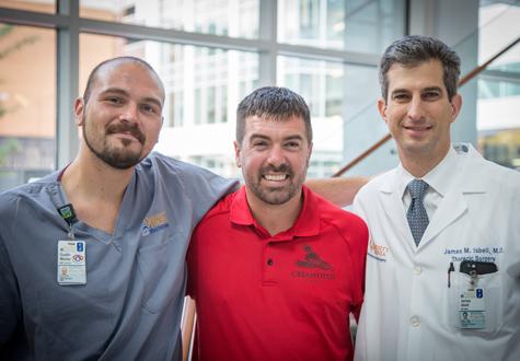 Grayson Kirby (center) recently reunited with his UVA care team, including ECMO specialist Dustin Money and James Isbell, MD.