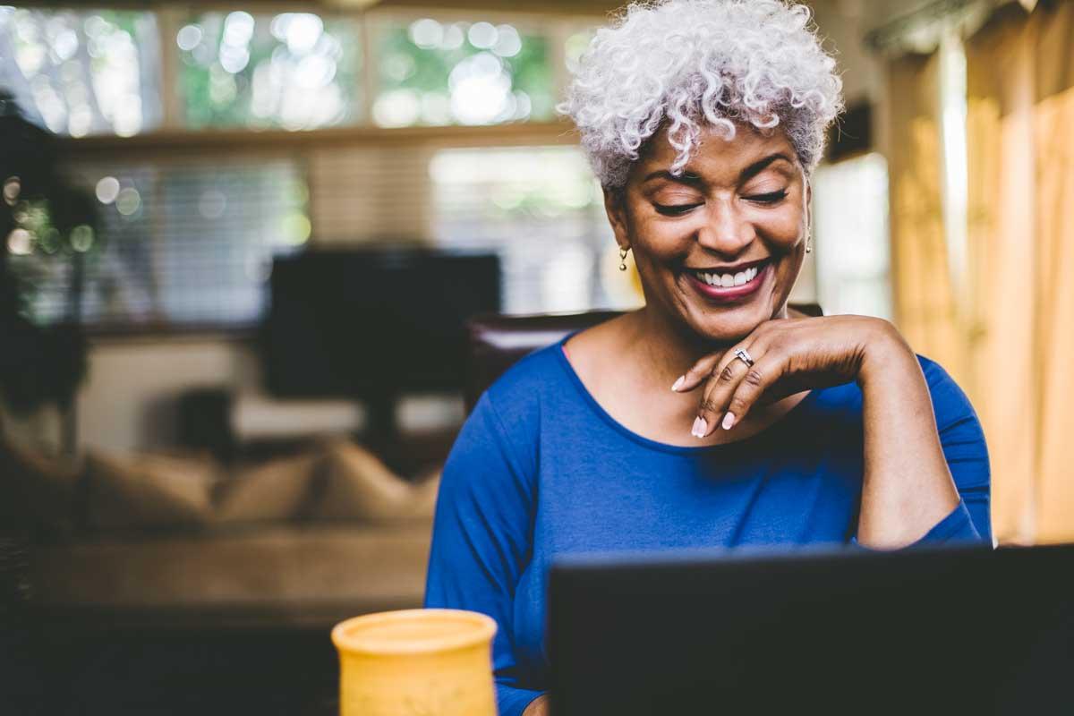 woman on her computer considering an at home stool test