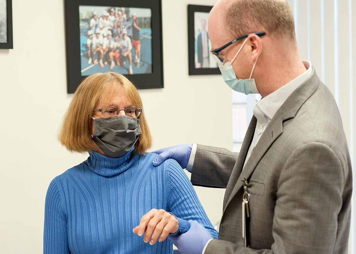 Dr. Werner moves Mary Lou's shoulder and arm after her outpatient shoulder replacement surgery