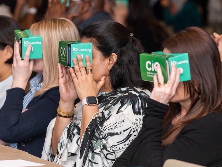 Attendees at the Symposium on Clinical Interventional Oncology watch a virtual reality video of an interventional radiology procedure performed at UVA.