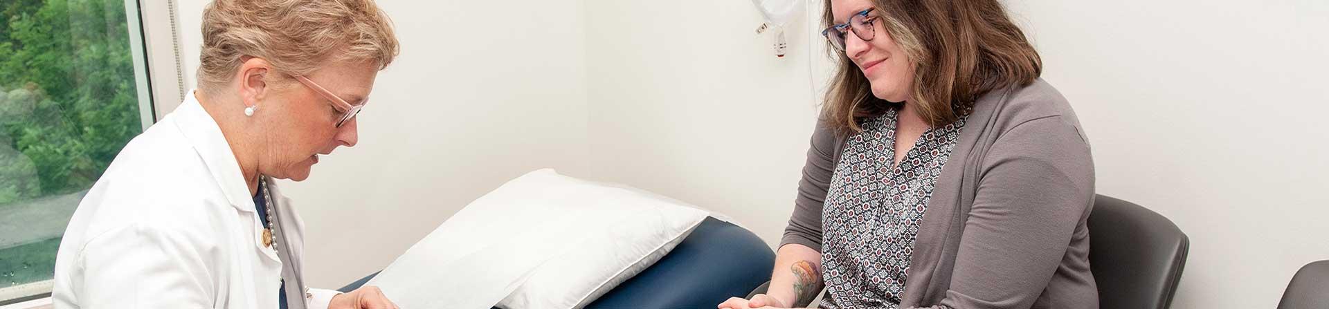 A healthcare provider discussing a patient's pelvic floor condition with them.