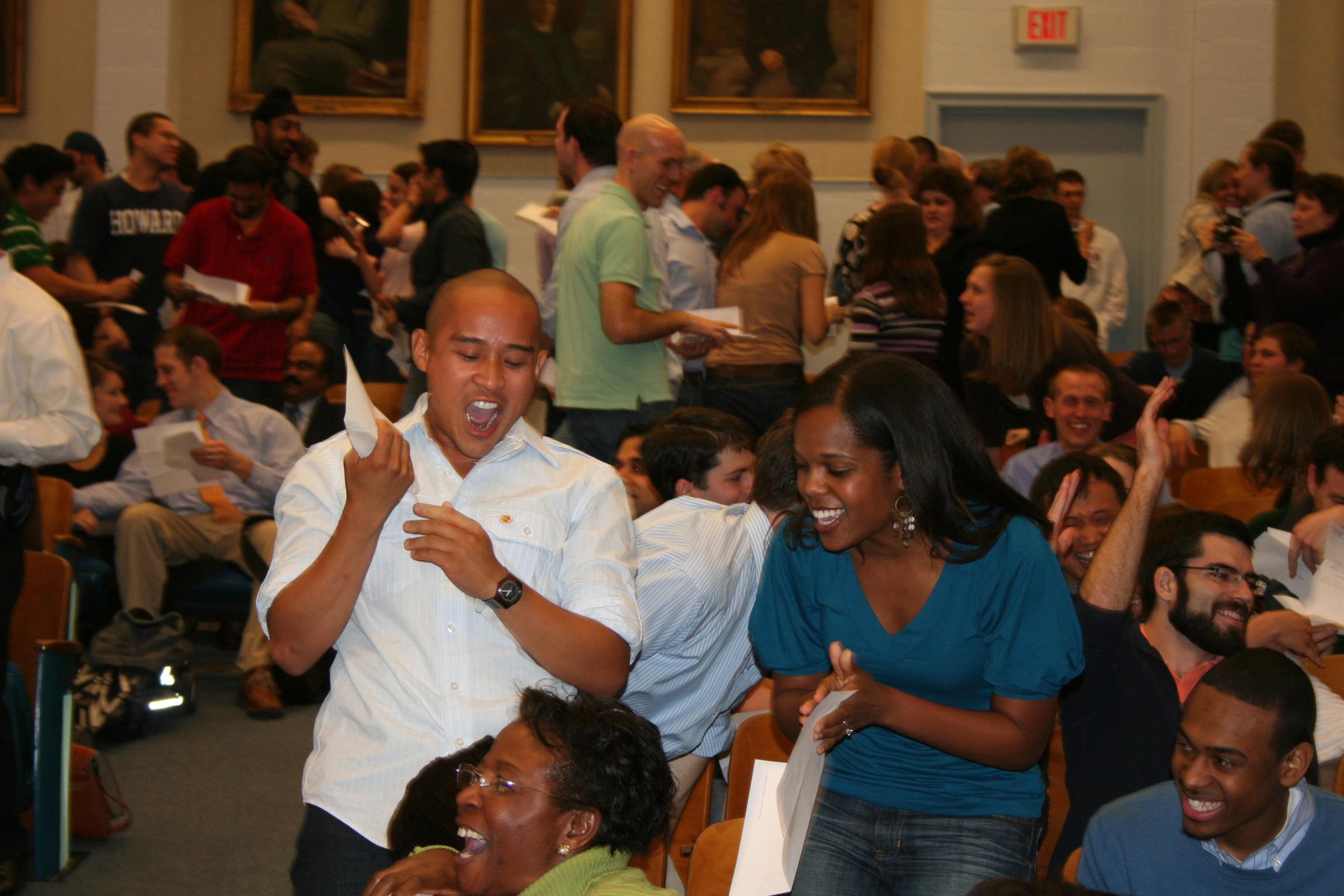 Fourth-year medical students Michael Auza and Leigh-Ann Jones react after opening their letters. Auza will study psychiatry in San Francisco and Jones will study emergency medicine in Chicago