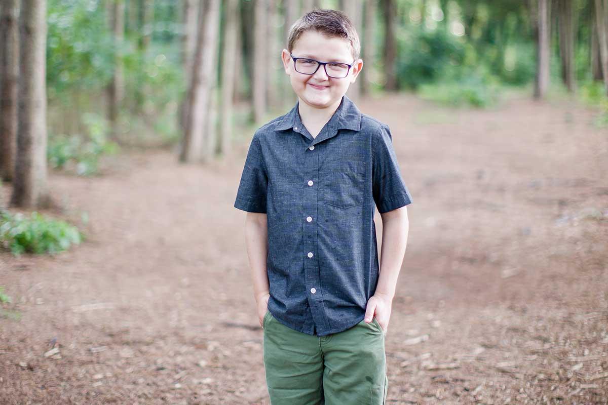 Conor standing outside, facing the camera and smiling