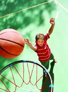 Keep your kids fit, healthy by playing games together, like basketball.