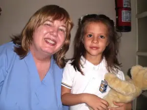Trena Berg, RN, poses with a 4-year-old Bolivian girl who had significant hearing loss. Volunteers gave the little girl a set of ear tubes.