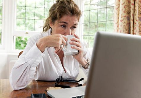 a woman looks online for info on screenings she needs