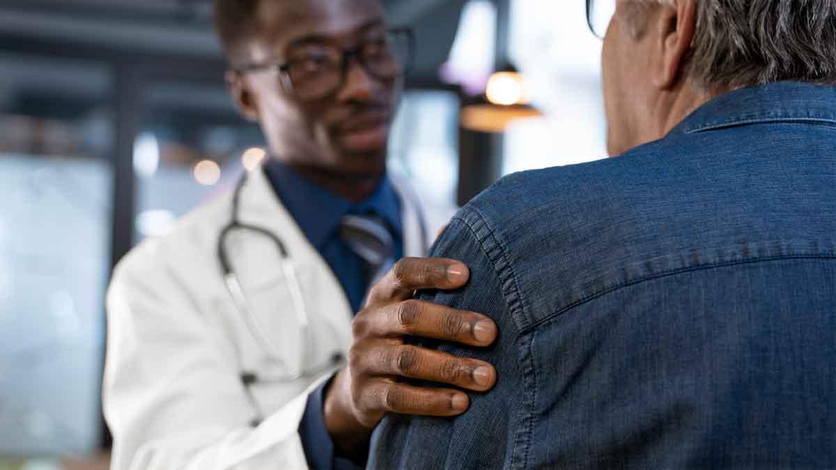 A doctor touching the arm of a sarcoma patient