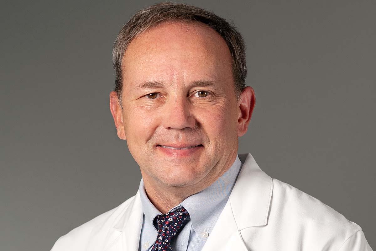 Portrait of breast radiologist Timothy Rooney, MD, wearing white coat
