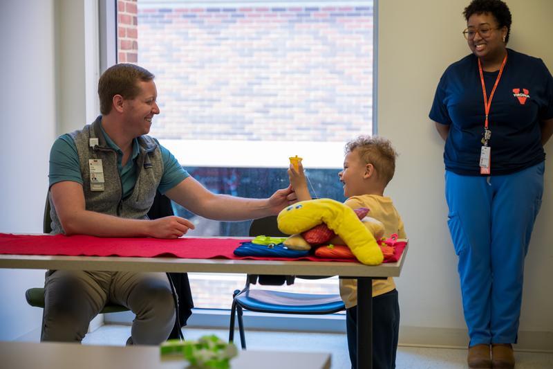 Pediatric patient high-fives a provider