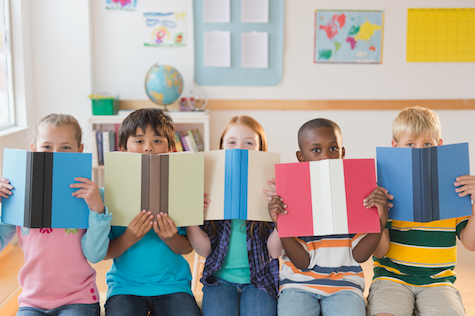 group of children with eyes peeking up above books